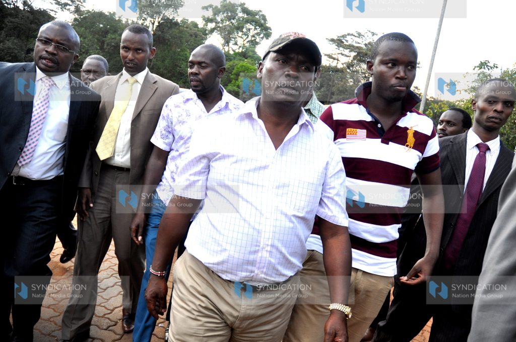 Kiambu Governor William Kabogo is escorted to the Nairobi CID headquarters