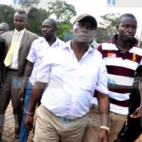 Kiambu Governor William Kabogo is escorted to the Nairobi CID headquarters