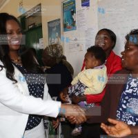 Phoebe Munya, wife of Meru Governor Peter Munya, shakes hands with women at Mikumbune Dispensary