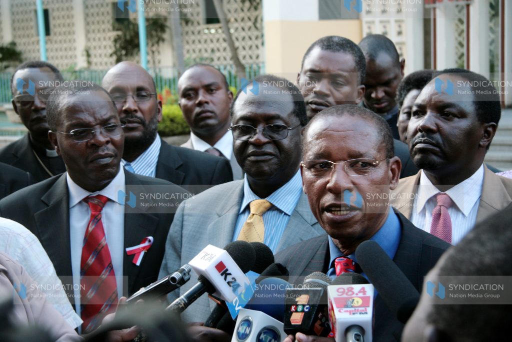 Minister for Justice and Constitutional Affairs Mutula Kilonzo (right) addresses journalists