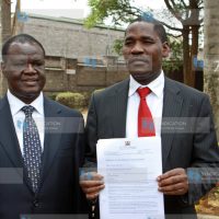 Peter Munya hold a copy of the petition to the British Government