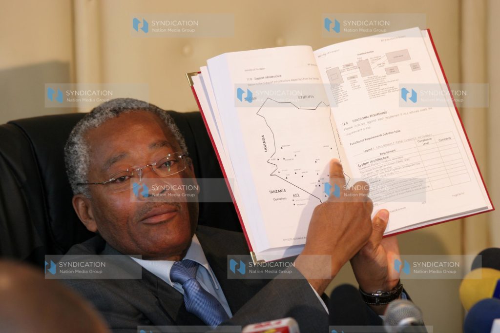 Transport Minister Chirau Ali Mwakwere reads out a clause in a report