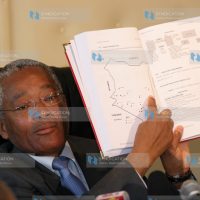 Transport Minister Chirau Ali Mwakwere reads out a clause in a report