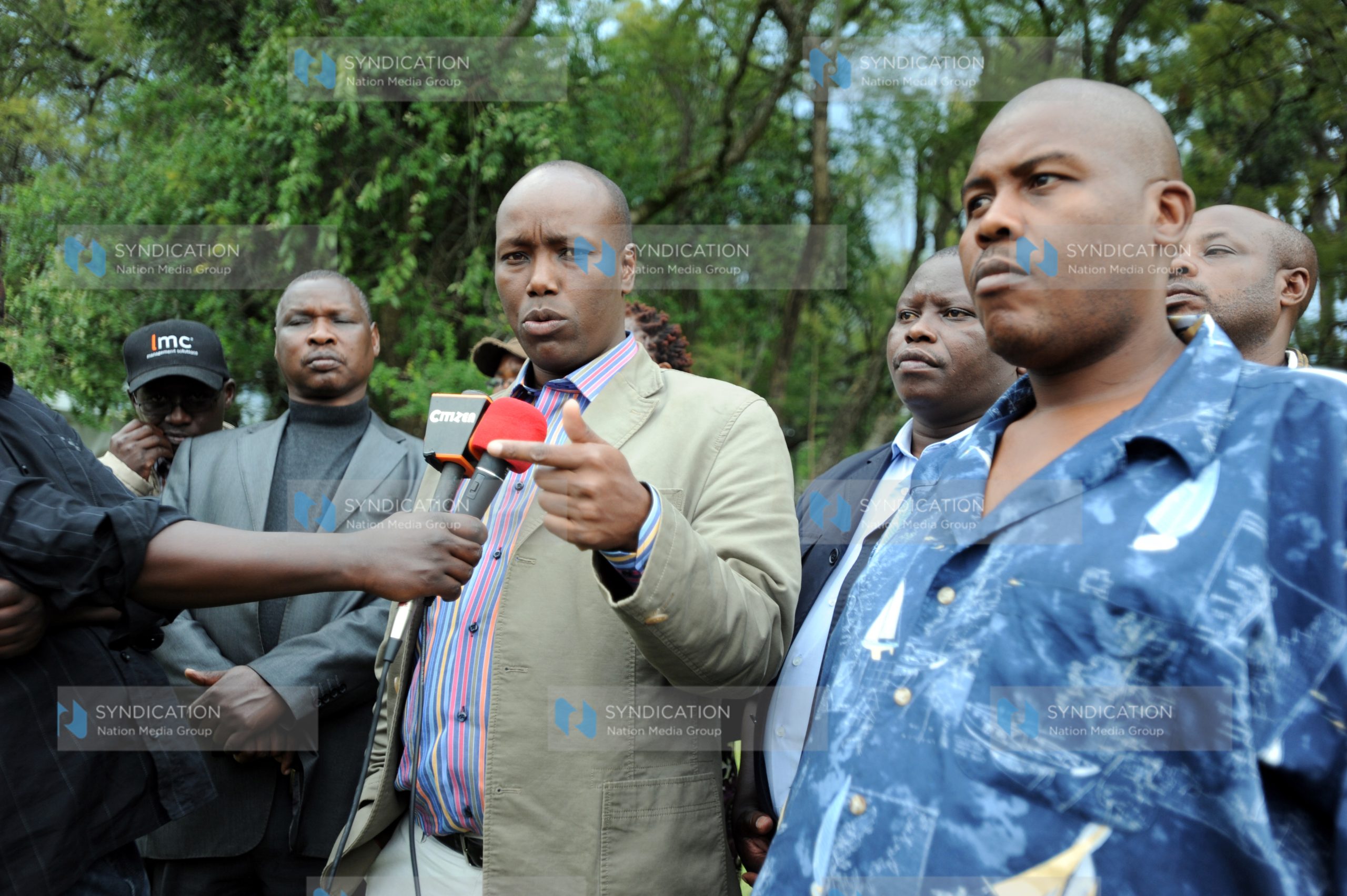 Nakuru Town MP Lee Kinyanjui, flanked by municipal councilors, addresses journalists