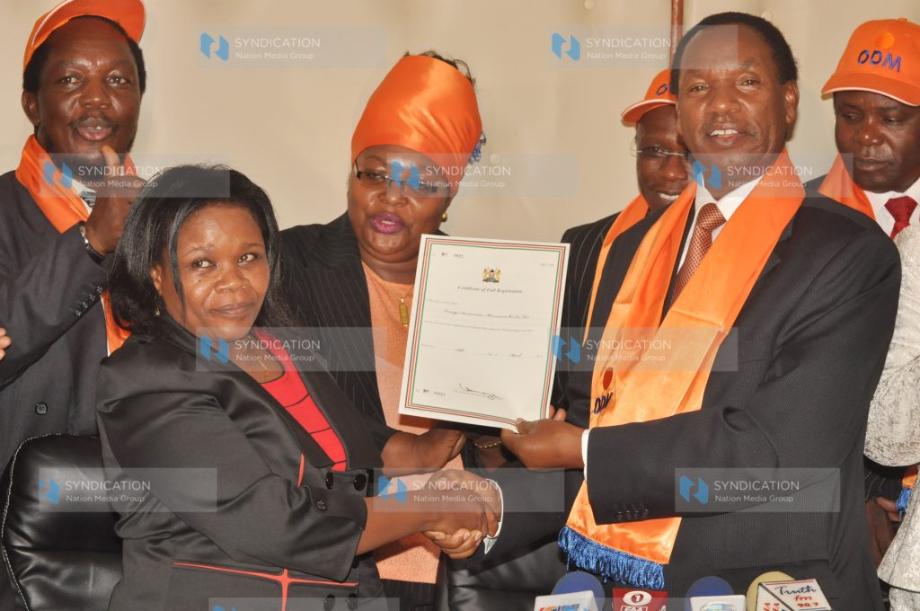 Henry Kosgey (right) receives the party full compliance certificate