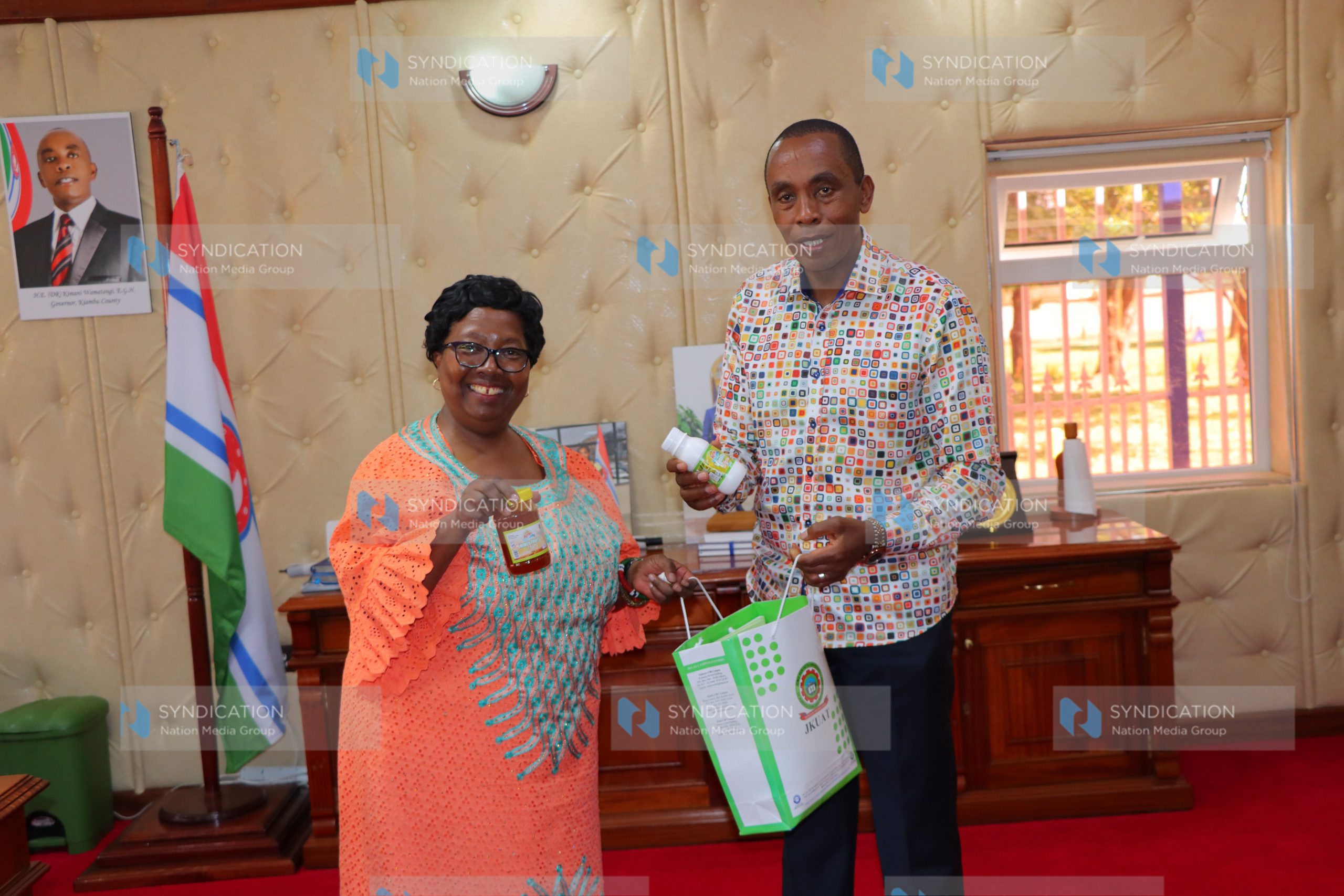 JKUAT Vice Chancellor Victoria Wambui Ngumi presents JKUAT value-added products to Kiambu County Governor Kimani Wamatangi
