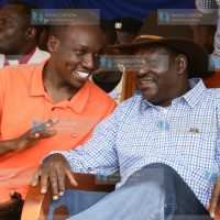Former Prime Minister Raila Odinga conversing with Dagoreti North MP Simba Arati