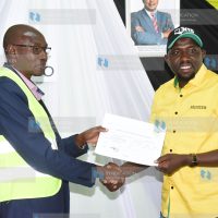 Elgeyo Marakwet Senator Kipchumba Murkomen receives a certificate from Charles Mutai