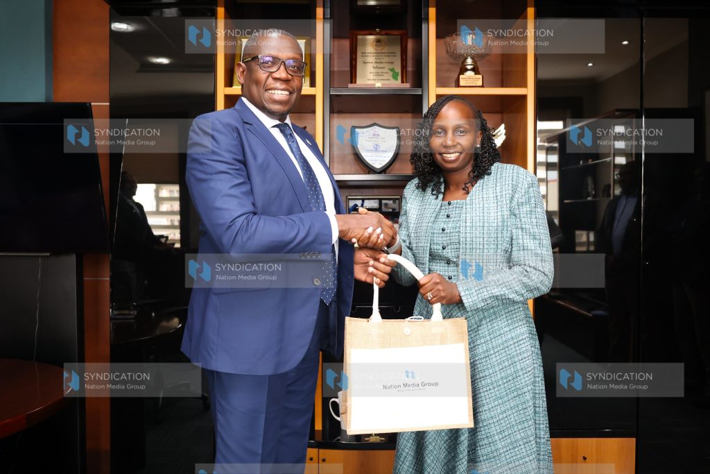 LSK President Faith Odhiambo receives a gift from NMG Managing Director and CEO Geoffrey Odundo
