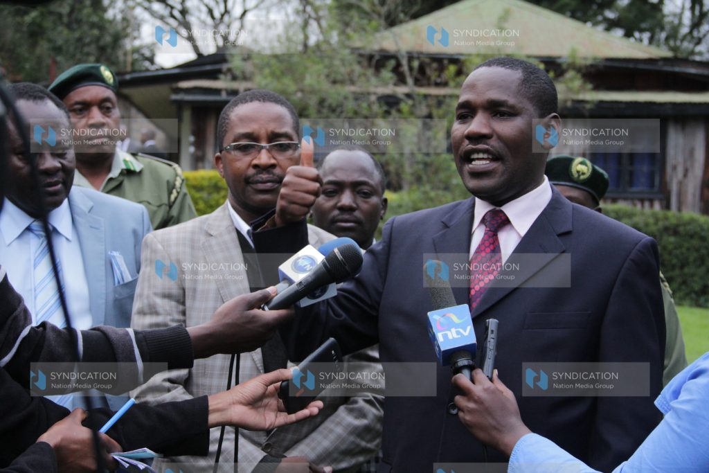 Meru County Governor Peter Munya, left, addresses journalists