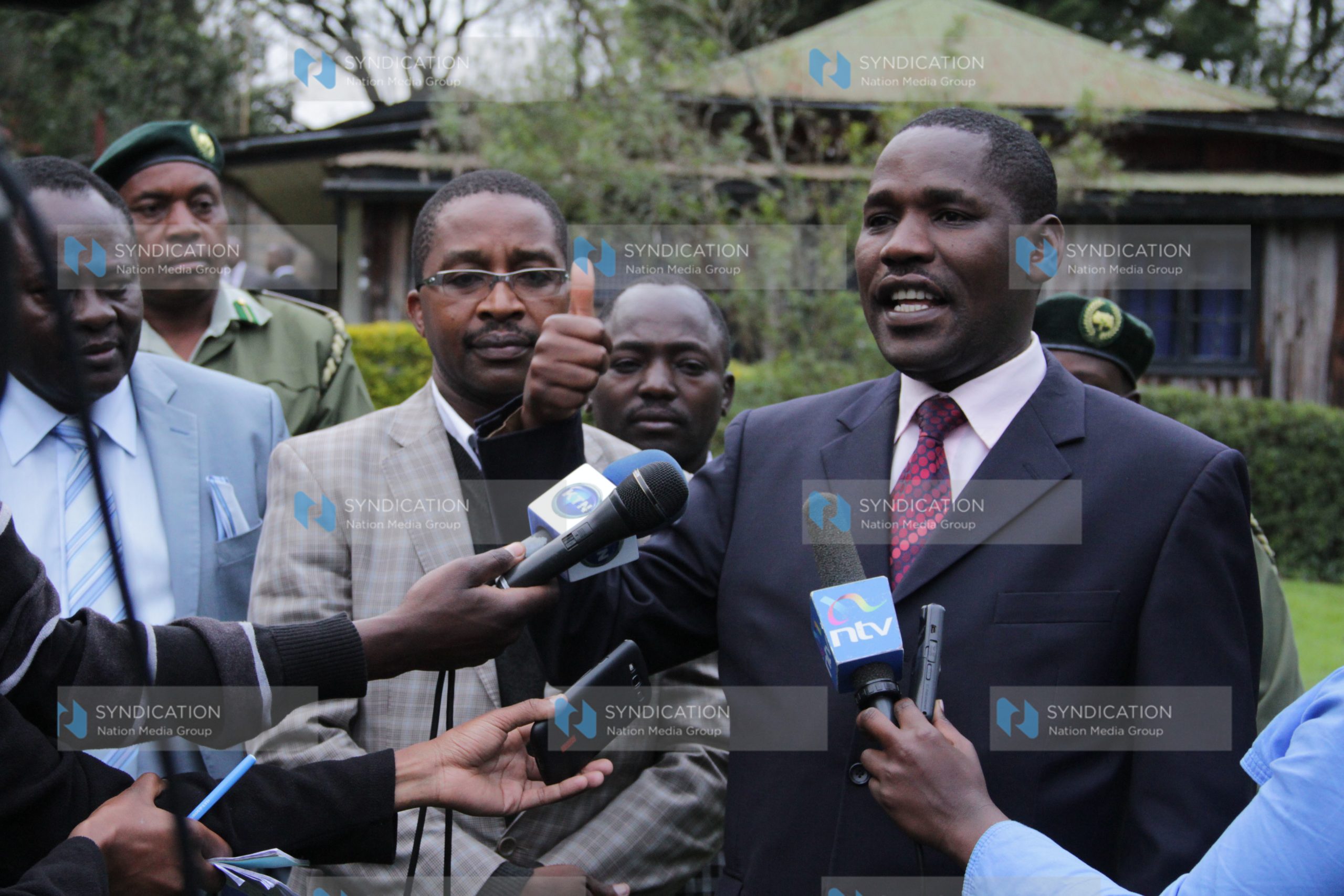 Meru County Governor Peter Munya, left, addresses journalists