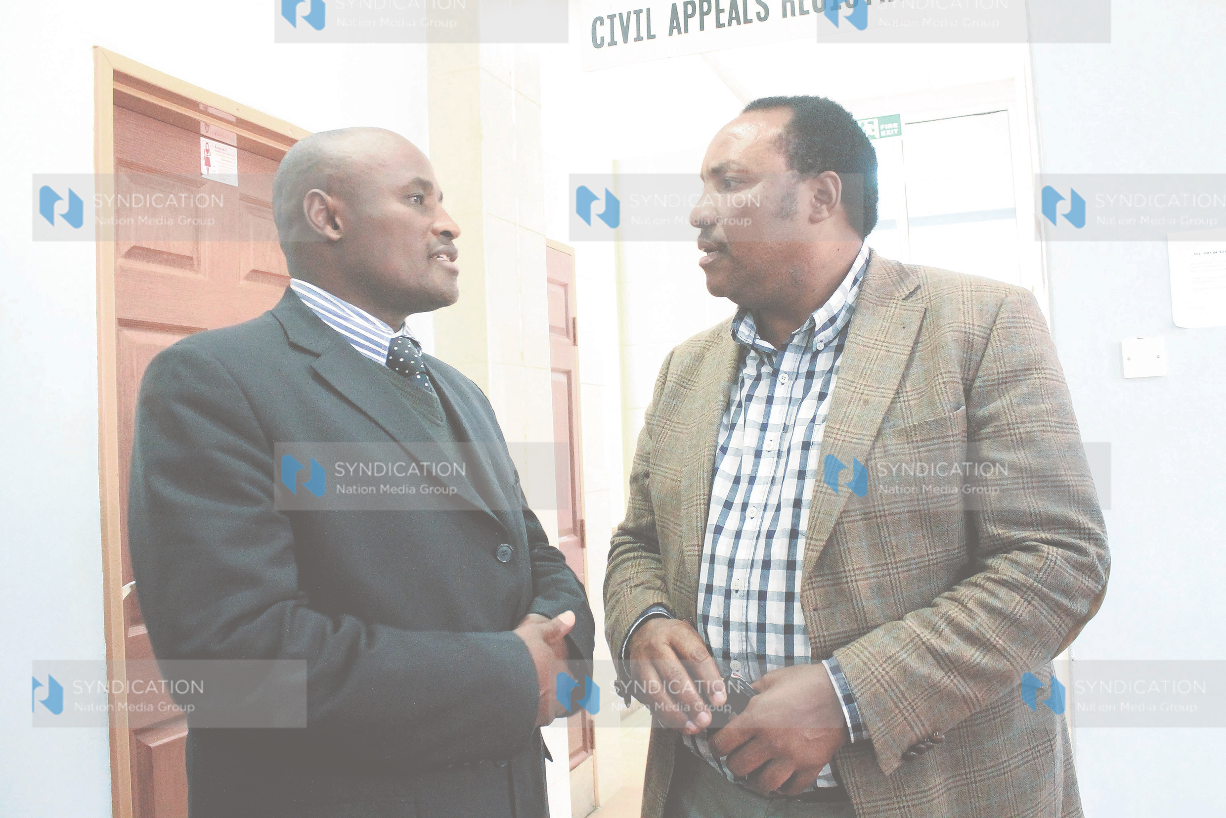 Lawyer Evans Ondiek (left) with Water Assistant Minister Ferdinand Waititu at the High Court
