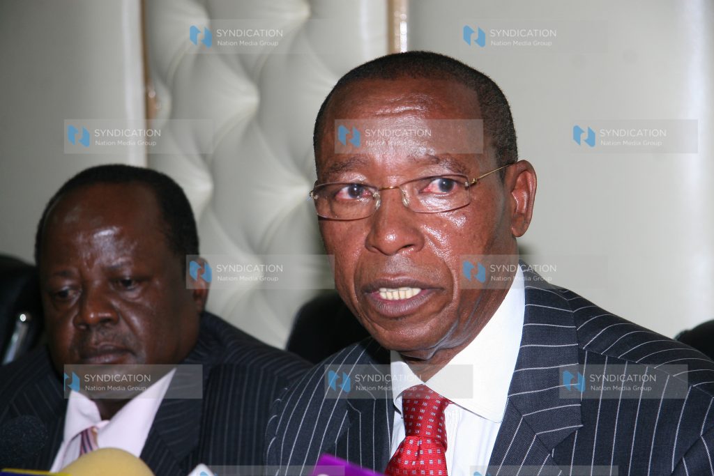 Minister for Education Mutula Kilonzo flanked by his permanent secretary George Godia