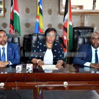 Rebecca Miano (center) makes her remarks during a press conference