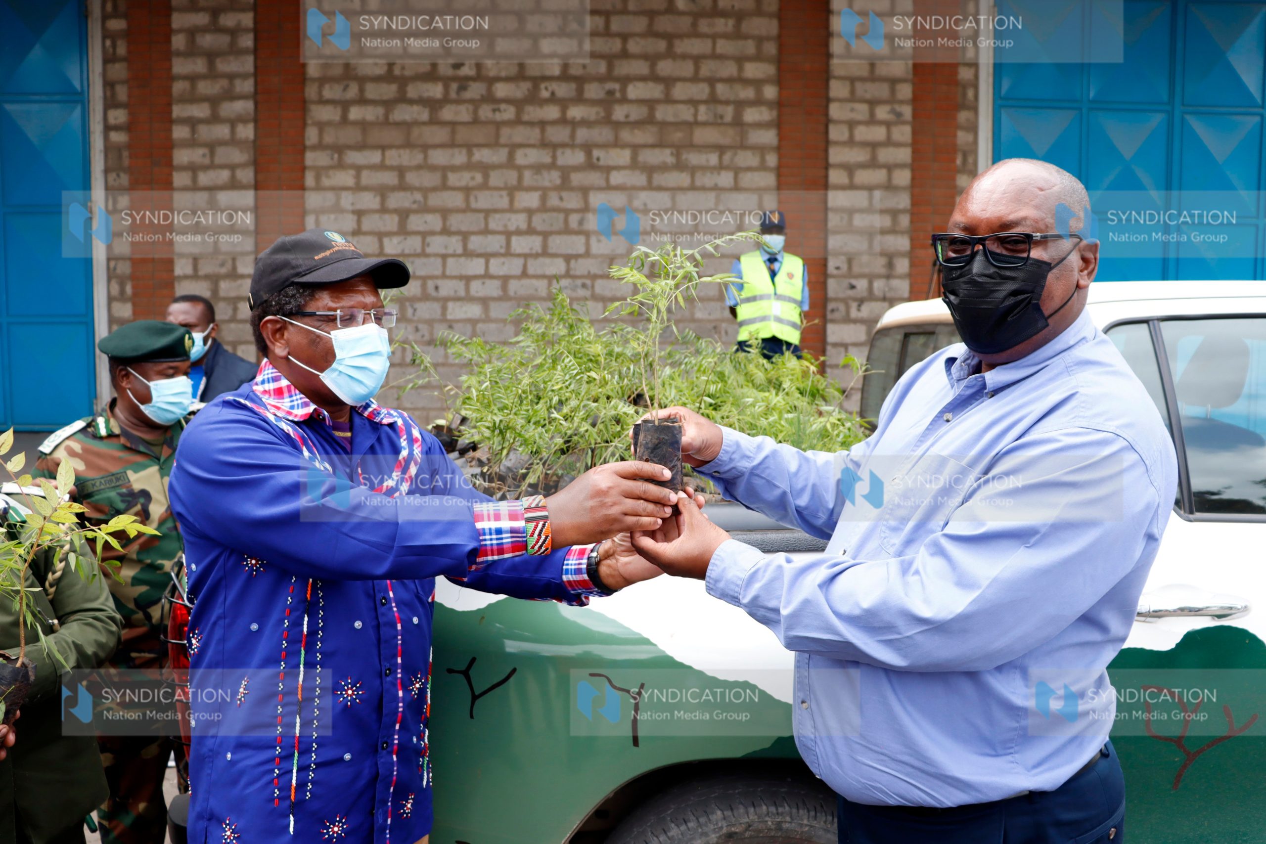 Ministry of Environment and Forestry Cabinet Secretary Mr. Keriako Tobiko (left) presents a tree seedling to NMG CEO Stephen Gitagama