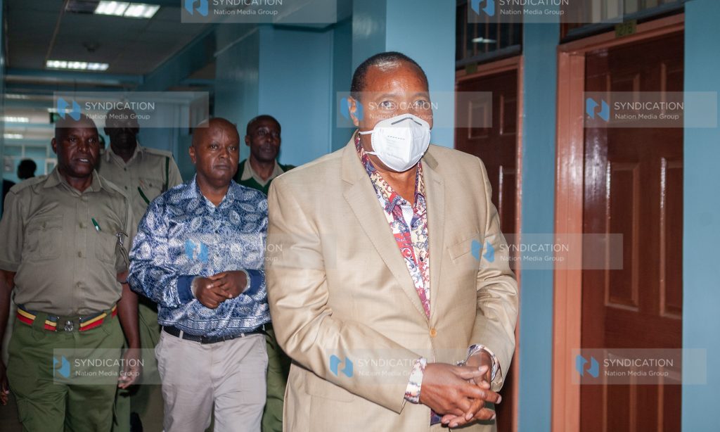 Former Kiambu Governor Ferdinand Waititu (front) with co-accused businessman Charles Chege being escorted to Milimani Law Courts