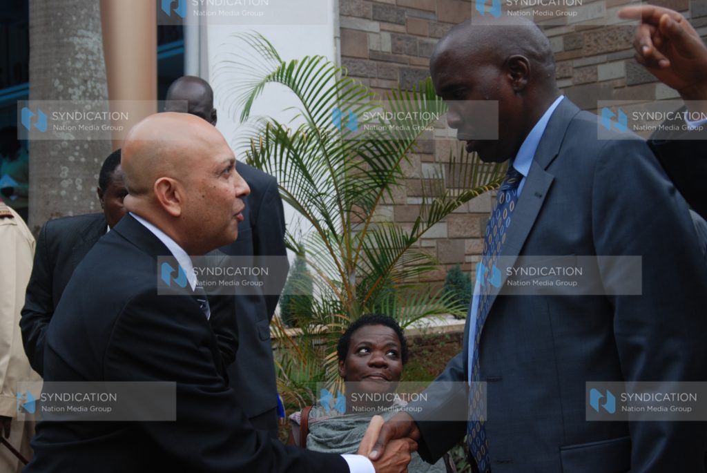 Interior Cabinet Secretary Joseph Ole Lenku greets RMA motors CEO Sanjiv Shah
