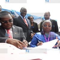 Dr. Custodia Mandlhate sign partnership documents at the Ministry of health offices