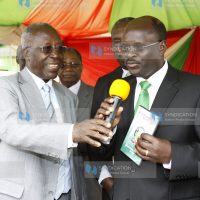 Minister for Education prof Sam Ongeri (left) hands over exams results to the Permanent Secretary prof James Ole Kiyiapi