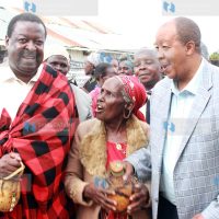 Musalia Mudavadi and former Njoro MP Joseph Kiuna dancing during a funds drive in aid