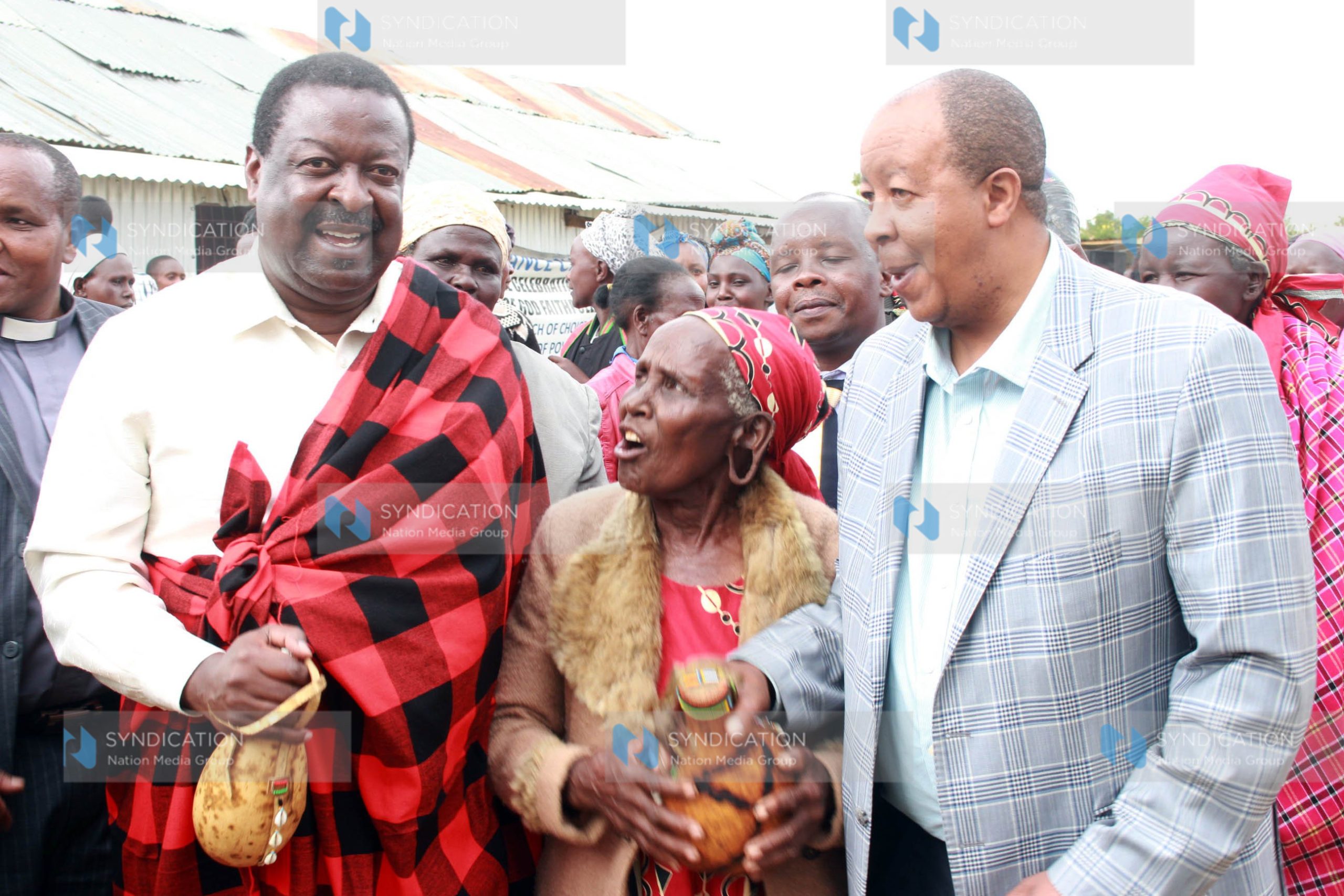 Musalia Mudavadi and former Njoro MP Joseph Kiuna dancing during a funds drive in aid