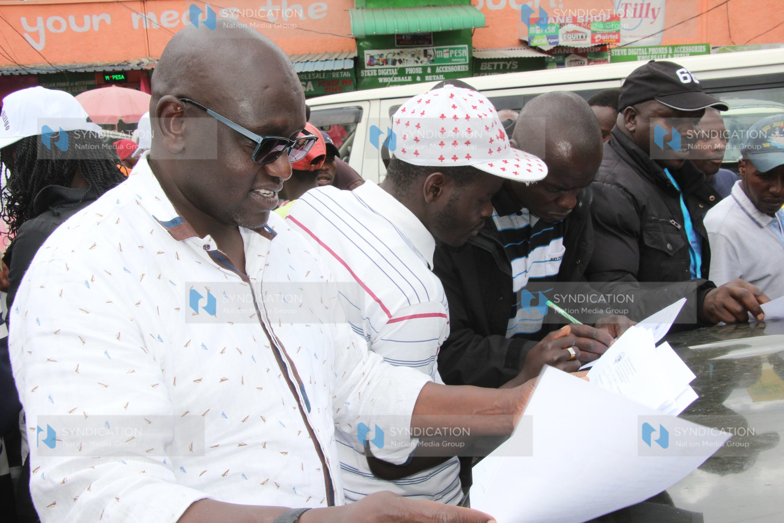 Ekuru Aukot (in glasses) collected signatures from members of the public