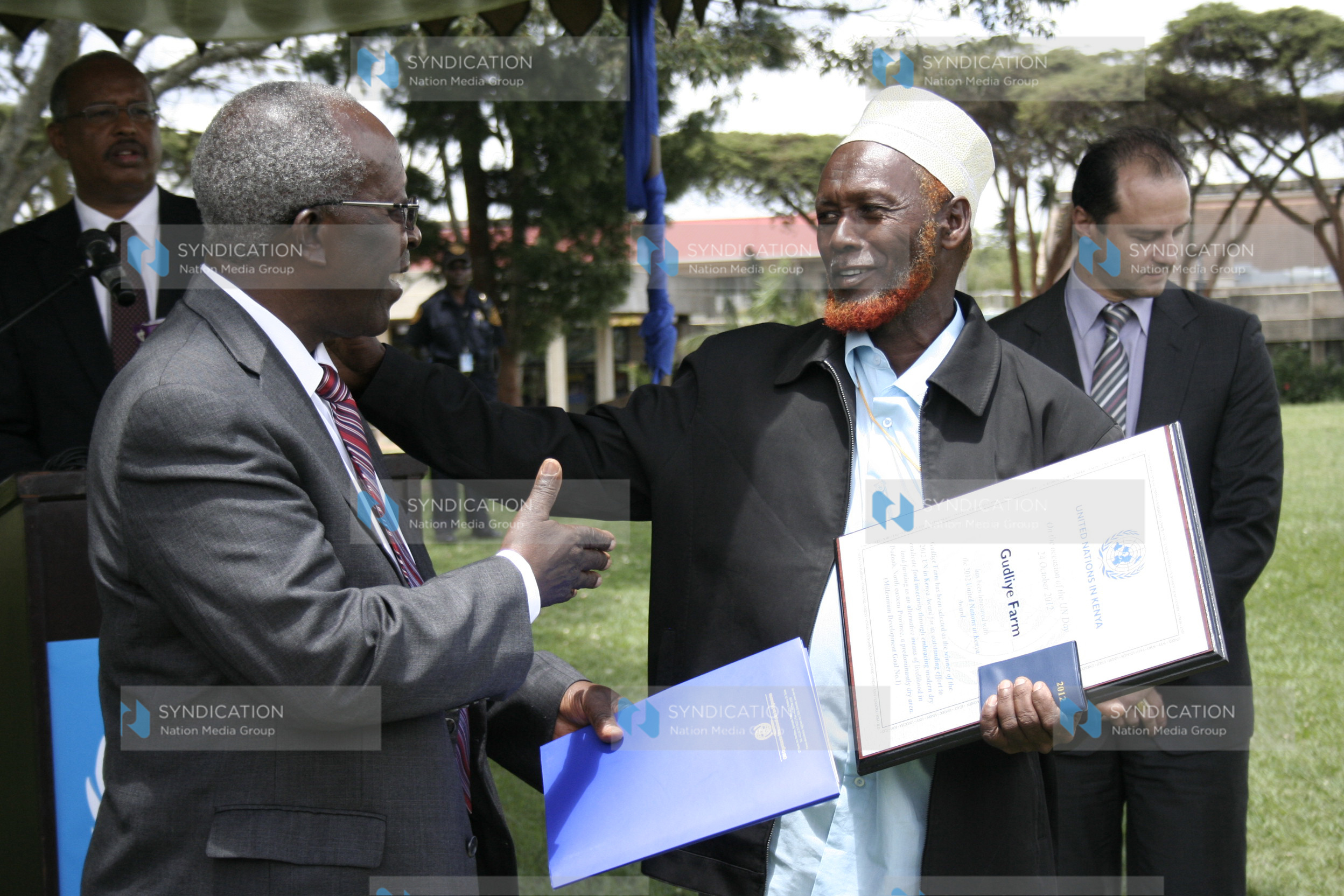 Gudliye farm chairman Issack Abdullahi Maalim receives the group’s award for being winners of the 2012 UN in Kenya