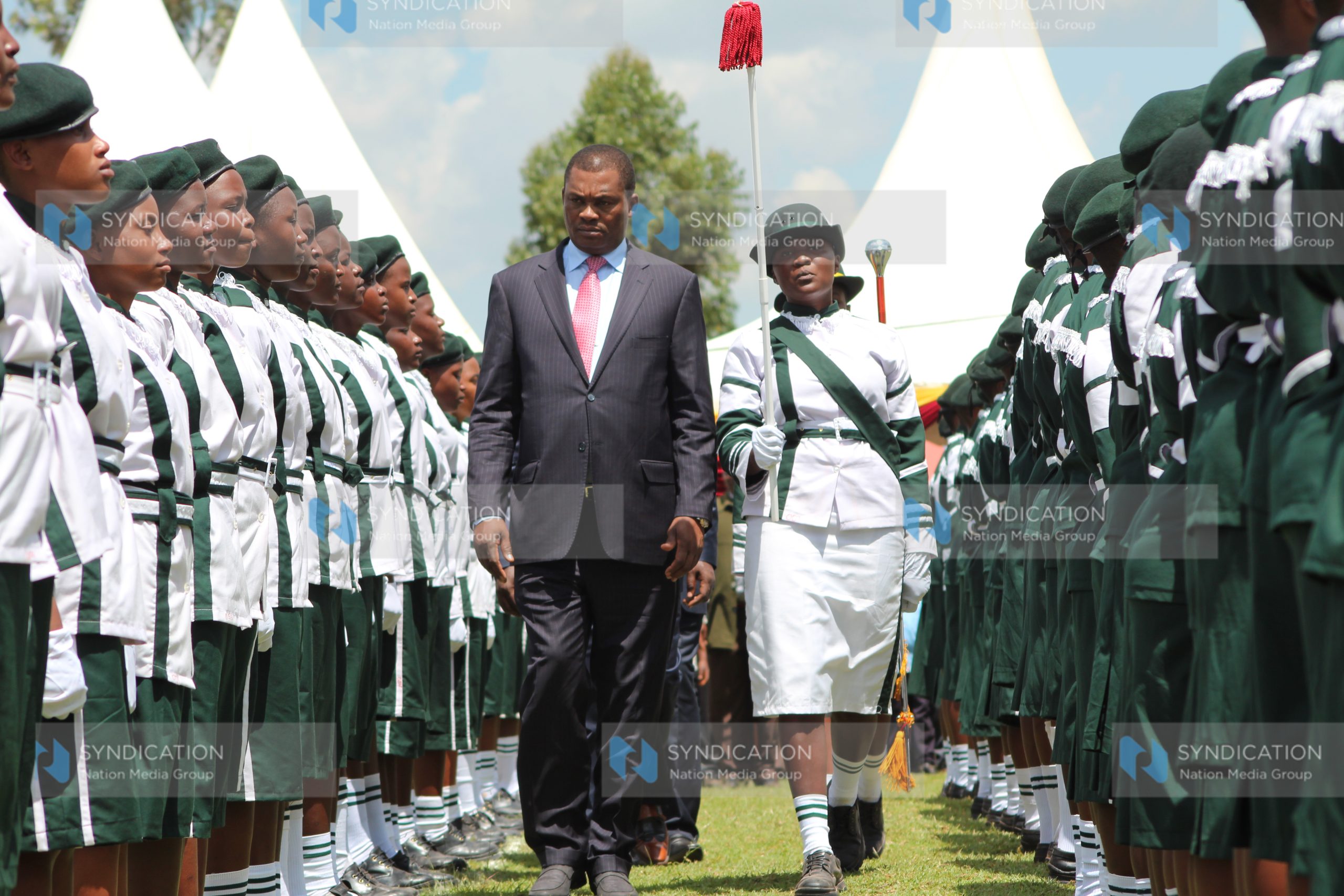 Justin Muturi inspects a parade of honour staged by Nyabururu Girls’ National School