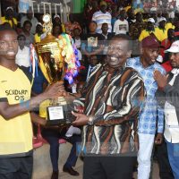 Prime Cabinet Secretary Musalia Mudavadi presents a trophy to Emmanuel Wanjala