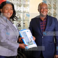 Wavinya Ndeti [L] handing over some documents to Transport, Infrastructure Housing, Urban Development and Public Works CS, James Macharia