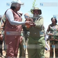 Environment CS Soipan Tuya joins conservationist Mary Wanjiku during a tree-planting exercise