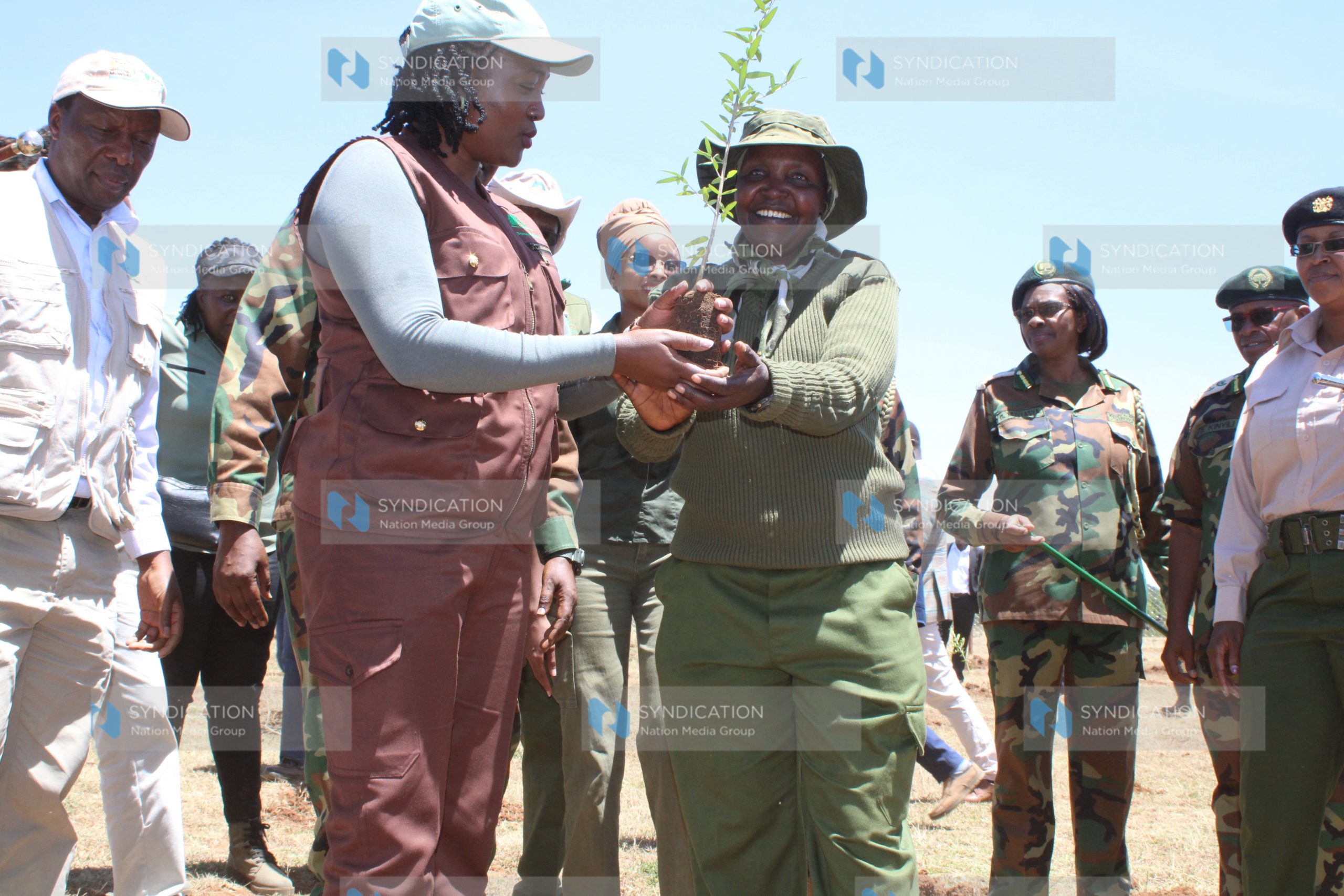 Environment CS Soipan Tuya joins conservationist Mary Wanjiku during a tree-planting exercise