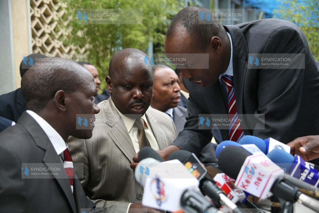 MPs Bonny Khalwale (left), Isaac Ruto and Lee Kinyanjui (right) consult before addressing a media briefing