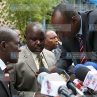 MPs Bonny Khalwale (left), Isaac Ruto and Lee Kinyanjui (right) consult before addressing a media briefing