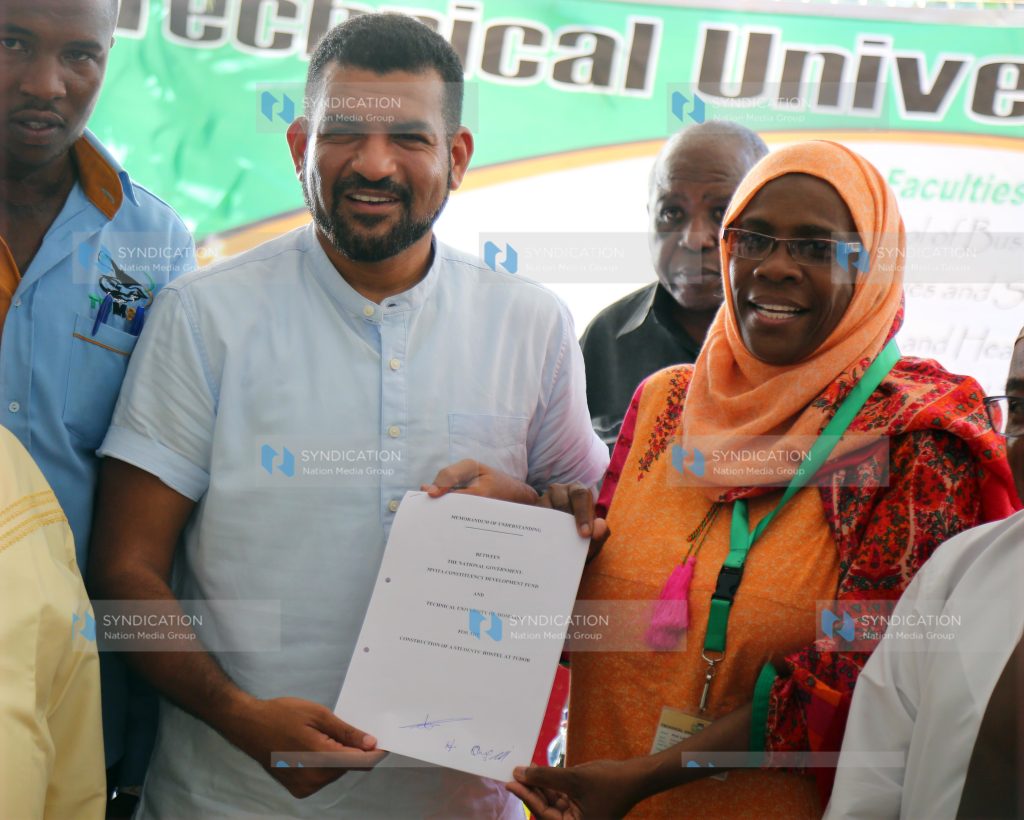 Mvita MP Abdulswamad Nassir holds a copy of the signed MOU with the Acting Vice Chancellor of the Technical University of Mombasa