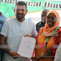 Mvita MP Abdulswamad Nassir holds a copy of the signed MOU with the Acting Vice Chancellor of the Technical University of Mombasa