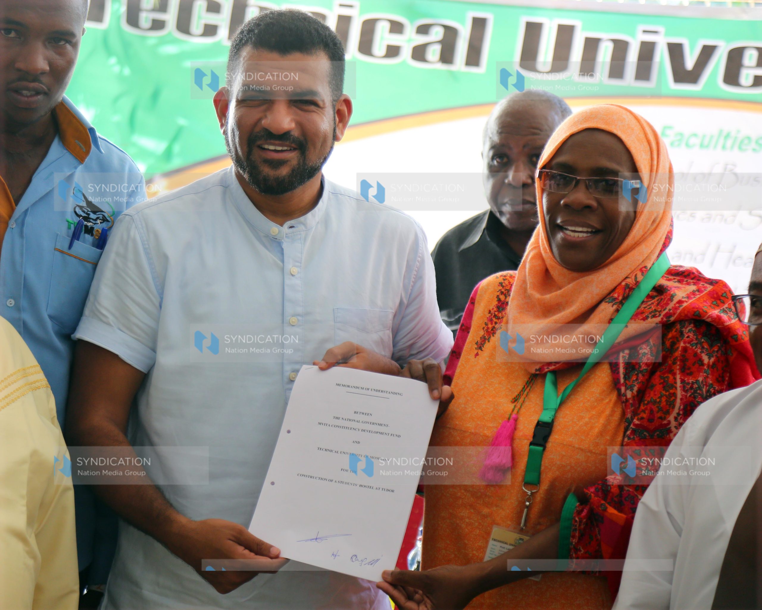 Mvita MP Abdulswamad Nassir holds a copy of the signed MOU with the Acting Vice Chancellor of the Technical University of Mombasa