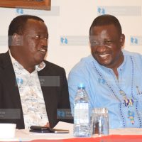 Devolution Principal Secretary Charles Sunkuli (L) speaks with Kwale Governor Salim Mvurya