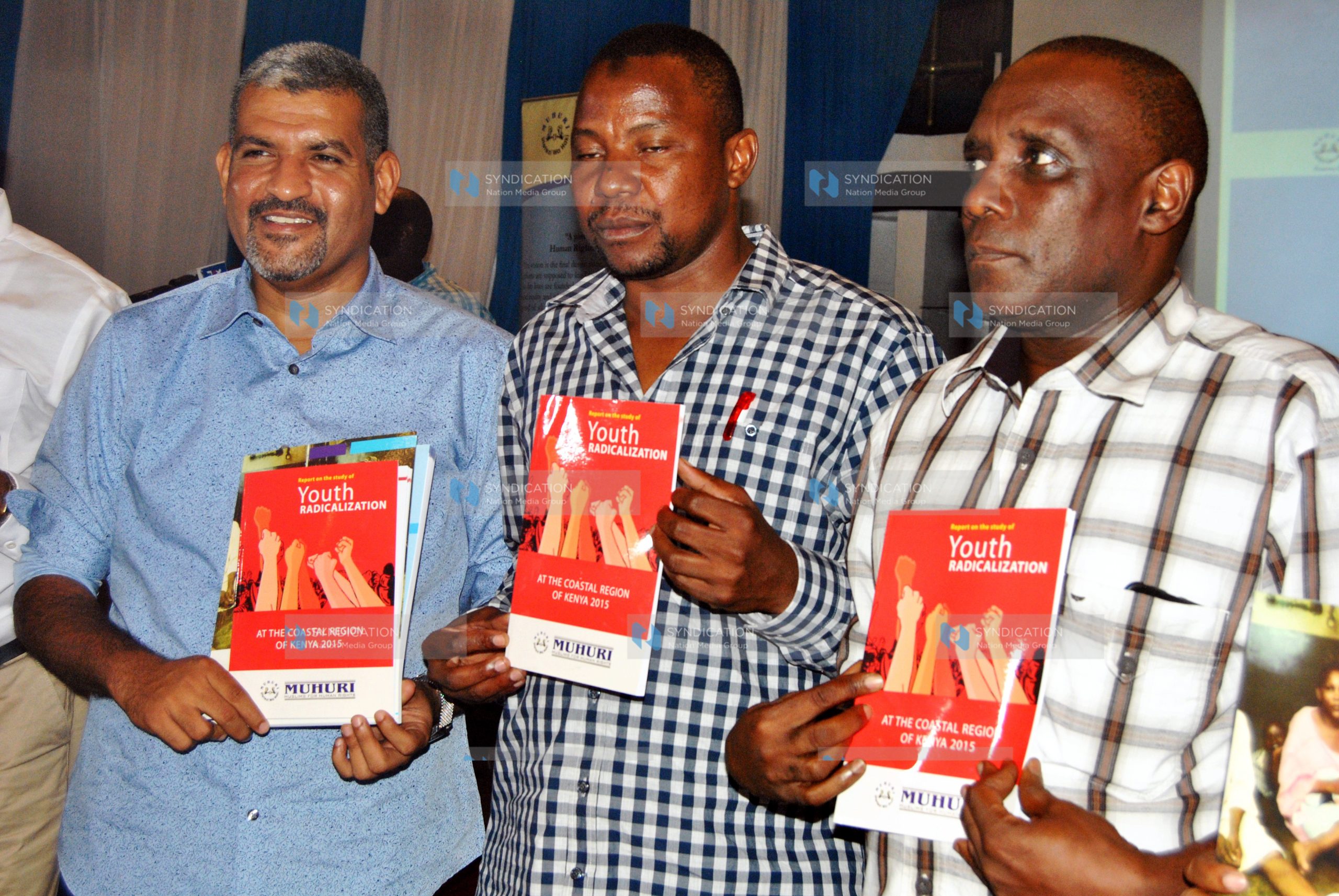 Abdulswamad Nassir, display copies of the report on the radicalization of youths in the Coast region at MUHURI offices