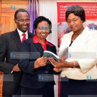 (from right) Youth and Gender Affairs Prof Margaret Kobia, Grace and her Husband James Kimathi sample the book titled "Couple Power" launched