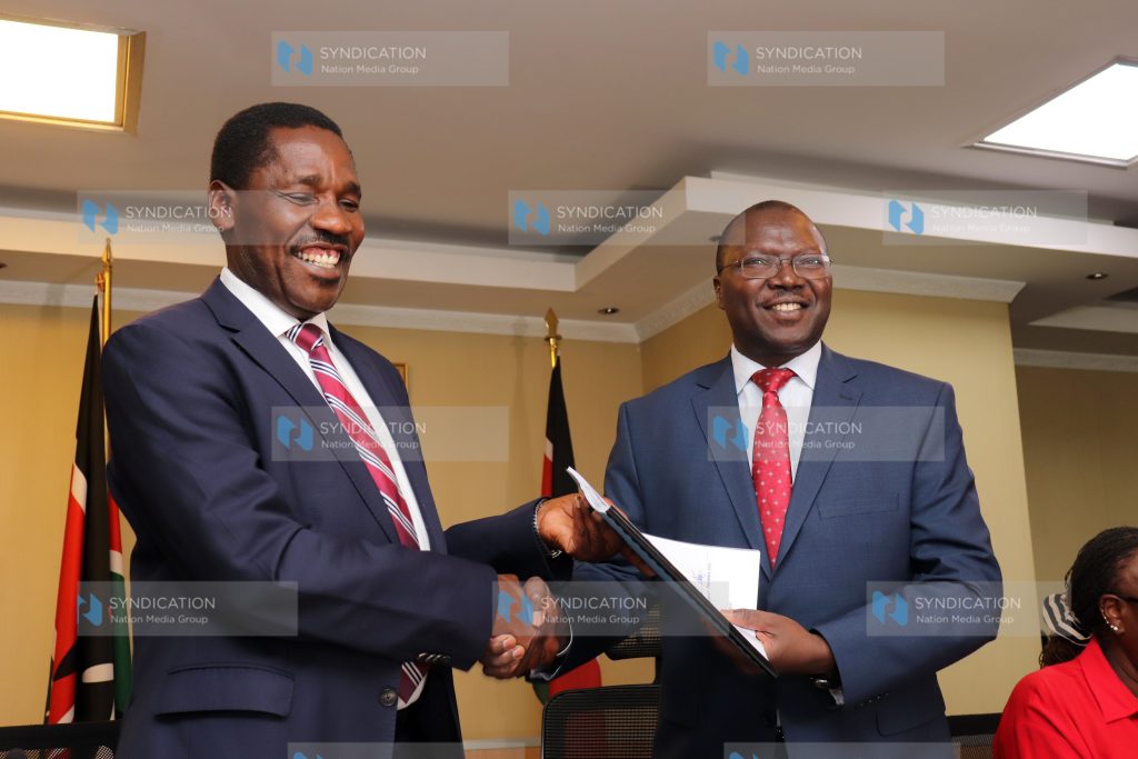 Outgoing Agriculture CS Peter Munya (left) handing over to the Incoming Cooperatives and Micro, Small and Medium Enterprise (MSMES) CS Simon Chelugui