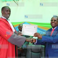 Embu Governor Martin Wambora (right) displays his certificate