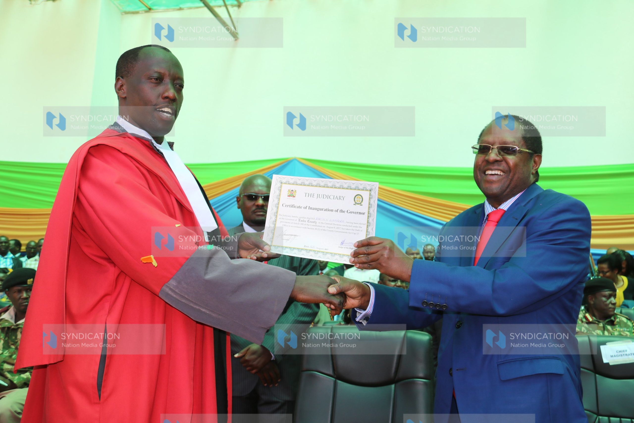 Embu Governor Martin Wambora (right) displays his certificate