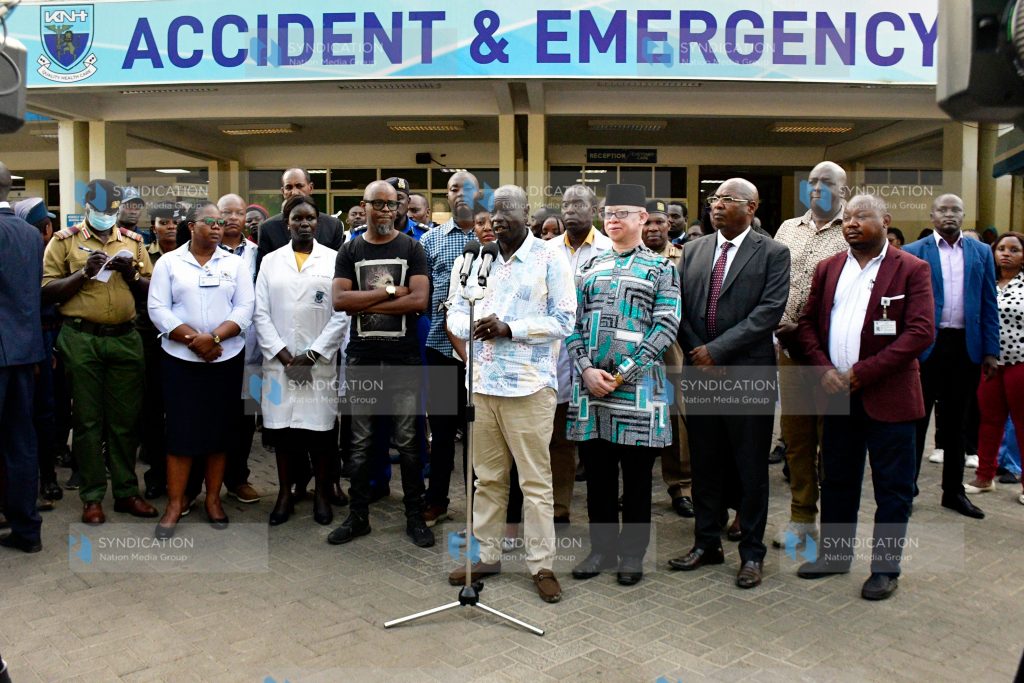 Deputy President Rigathi Gachagua (center) briefs citizens outside the casualty wing of Kenyatta National Hospital (KNH)