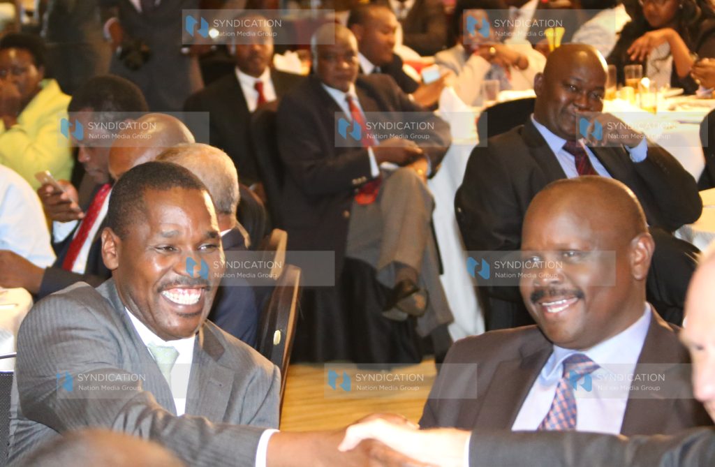 Outgoing Council of Governors (CoG) Chair Isaac Ruto with incoming Council Chair Peter Munya