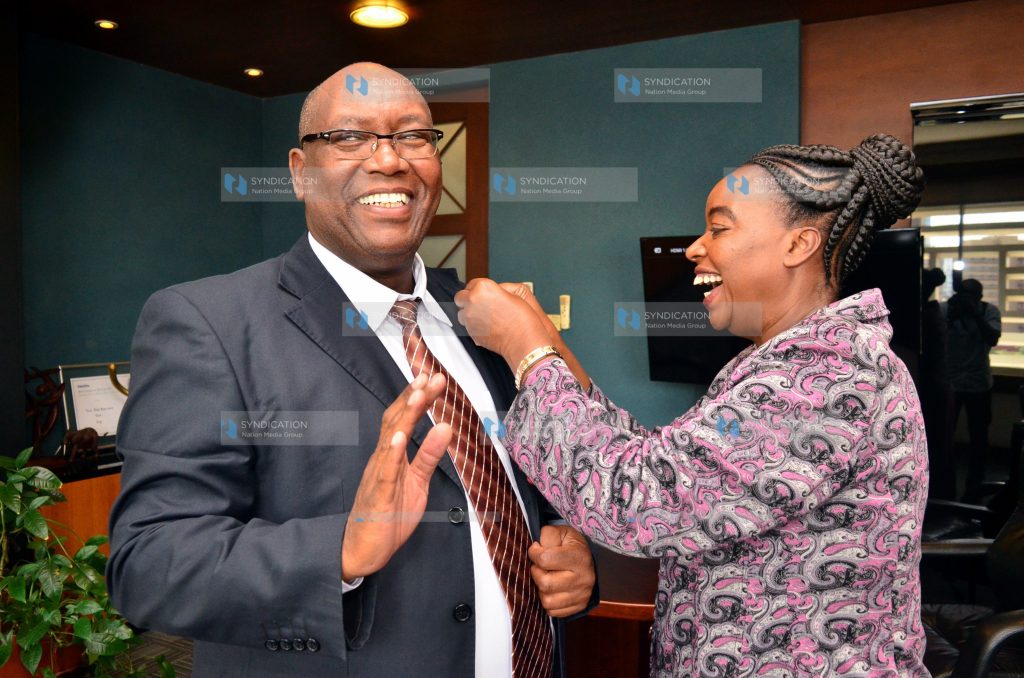 Ministry of Foreign Affairs Cabinet Secretary Monica Juma (right) pins Nation Media Group (NMG) Group Chief Executive Officer Stephen Gitagama