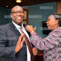 Ministry of Foreign Affairs Cabinet Secretary Monica Juma (right) pins Nation Media Group (NMG) Group Chief Executive Officer Stephen Gitagama
