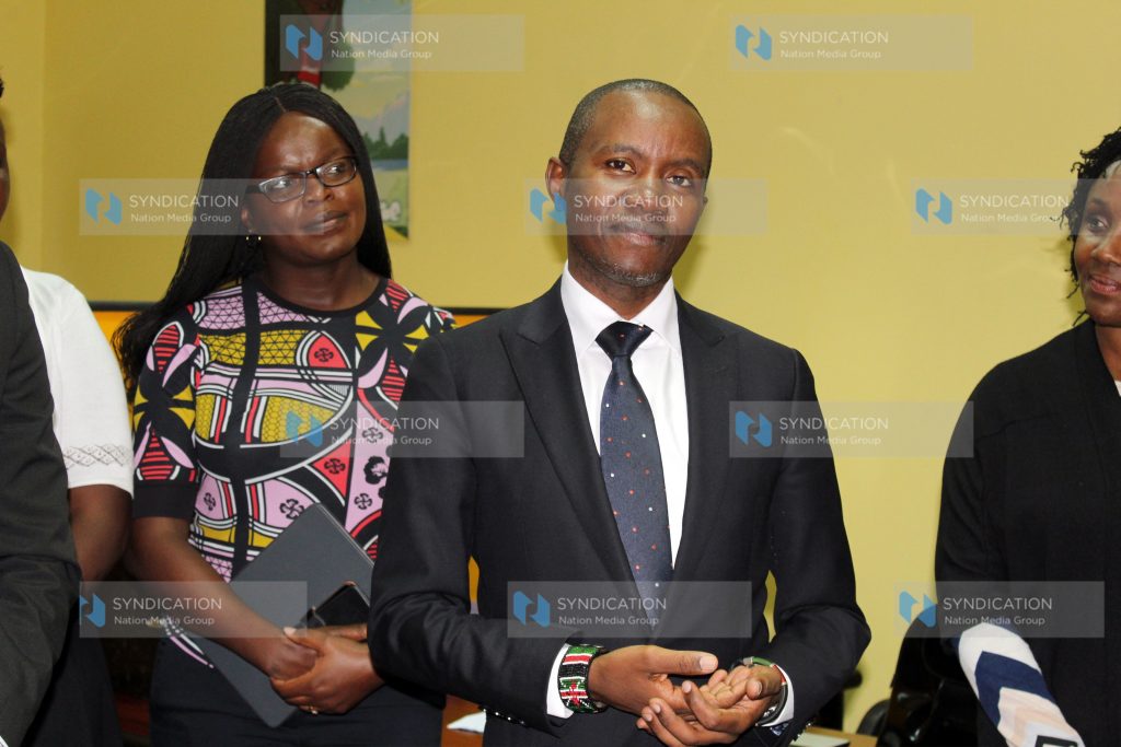ICT Cabinet Secretary Joe Mucheru receives a gift from Kenya Film Commission Chairperson Dorothy Ghettuba