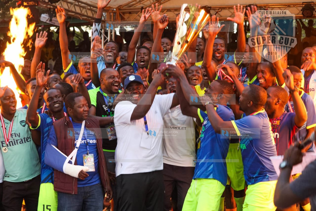 MP of Ikolomani Benard Shinali and Senator of Kakamega Cleophas Malala celebrate with players of Lirhembe Arsenal FC