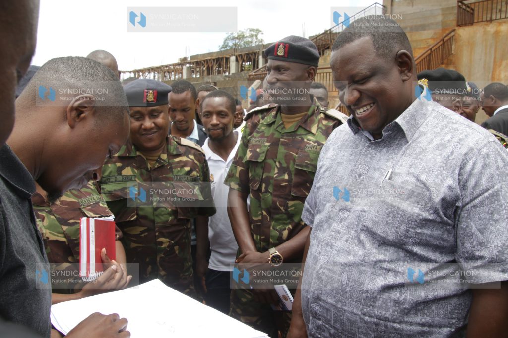 Sports CS Salim Mvurya and KDF officers review a new design for Ruring'u Stadium